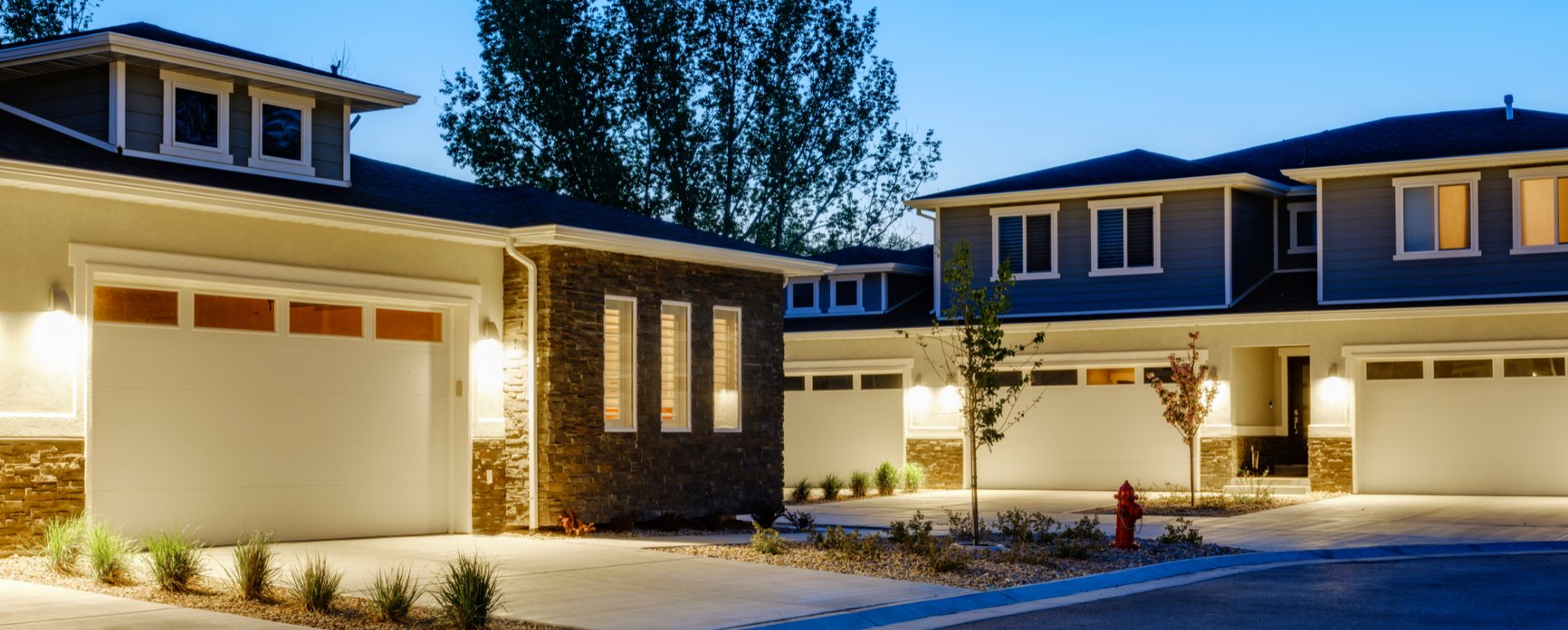 Well-lit suburban La Mesa homes with modern, secure garage doors at dusk