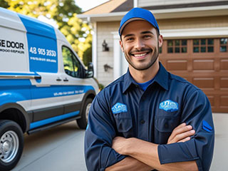 Garage Door Company Expert Technician La Mesa Professional garage door technician standing in front of service van and residential garage door.